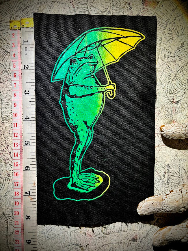 Sad frog holding an umbrella in the rain sew on patch.