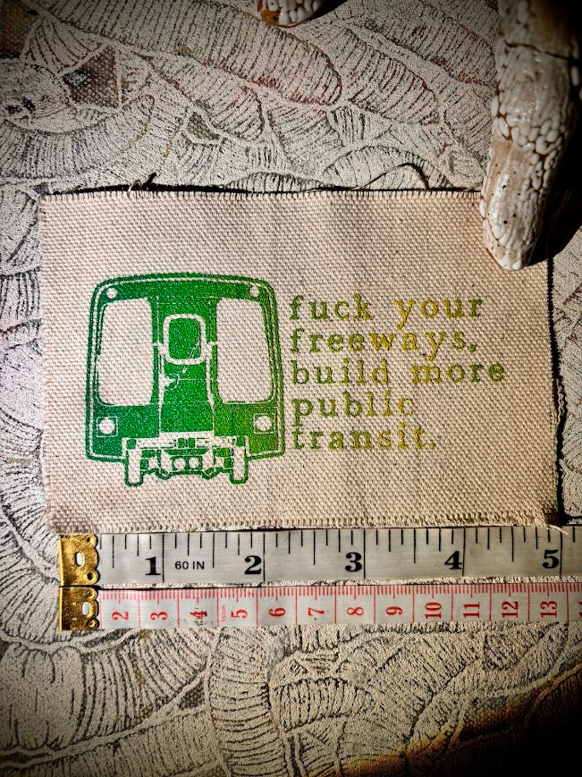 Fuck your freeways, build more public transit sew on patch.
