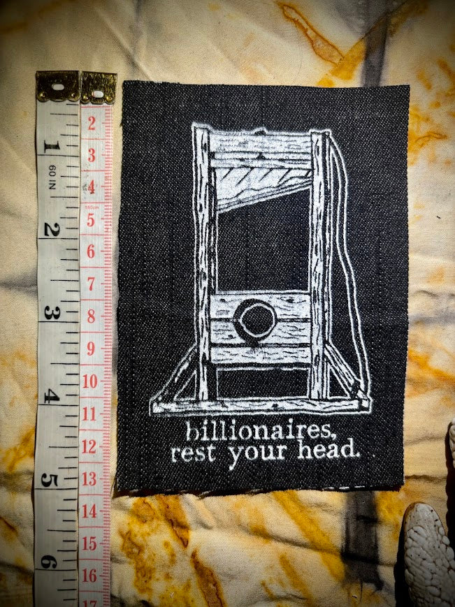 Guillotine sew on patch. Billionaires, rest your head