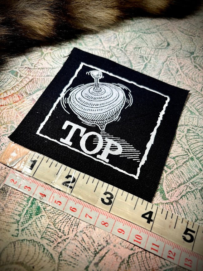 Top, completely innocent double entendre patch.