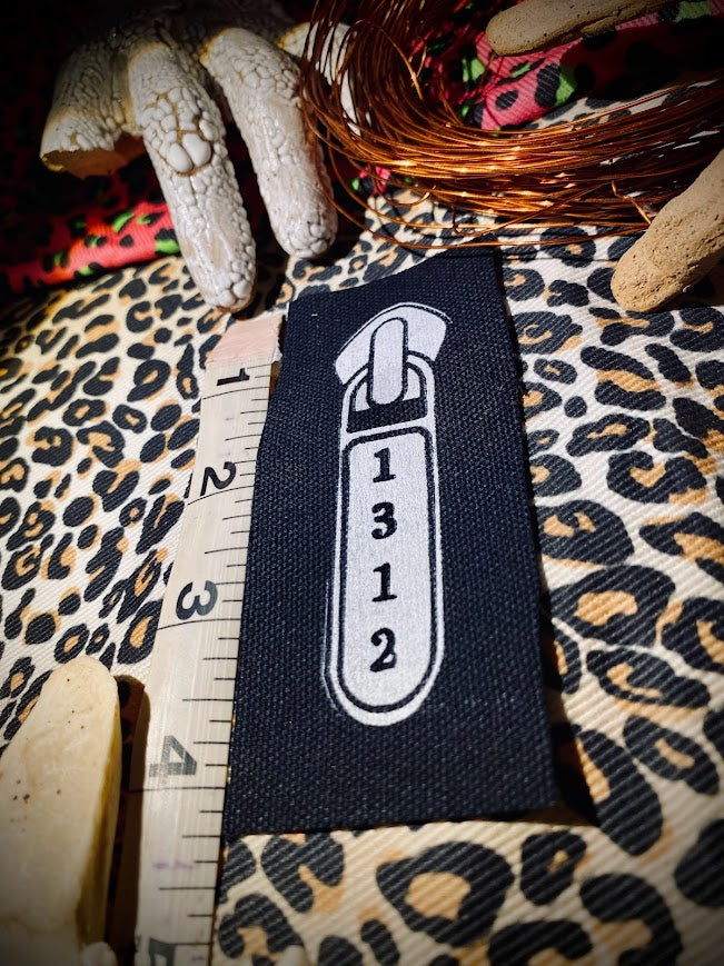 1312 ACAB zipper pull.
