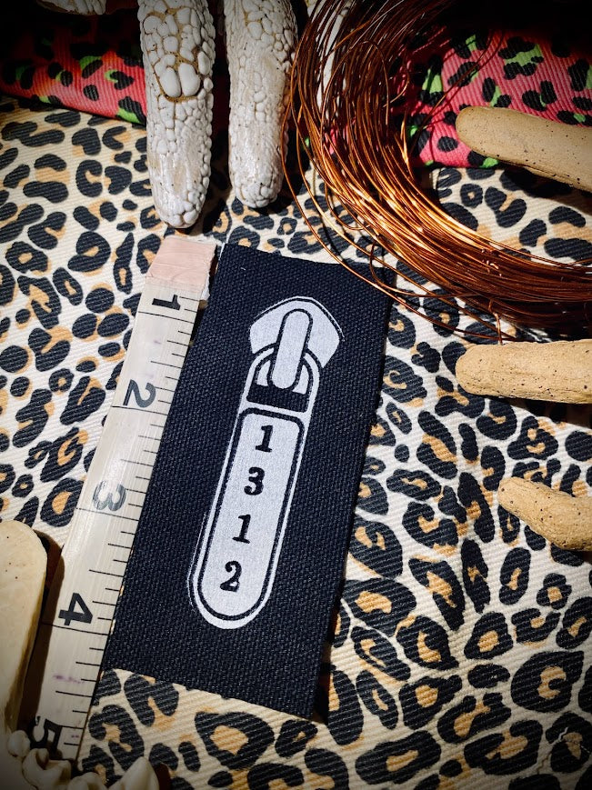 1312 ACAB zipper pull.