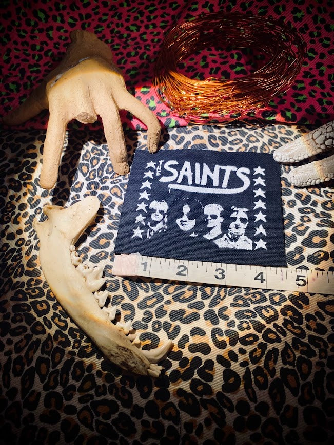 The Saints sew on patch.