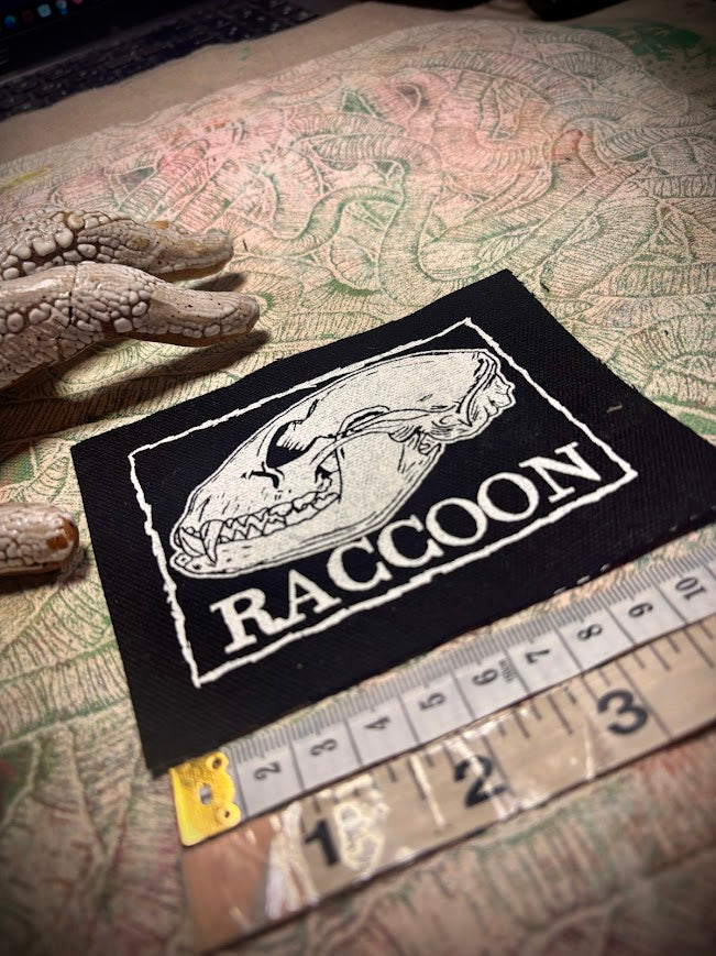 Raccoon skull patch.