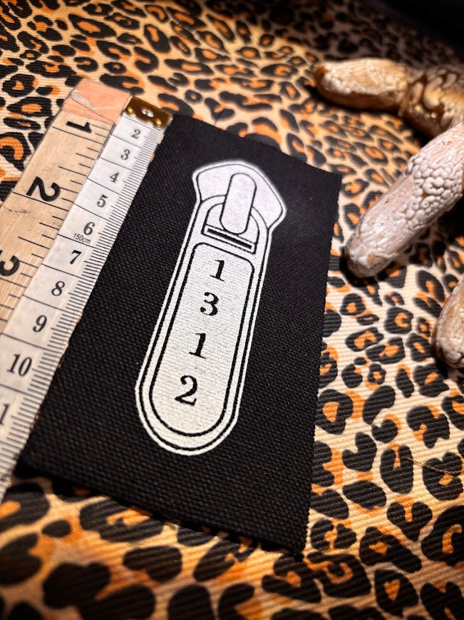 1312 ACAB zipper pull.
