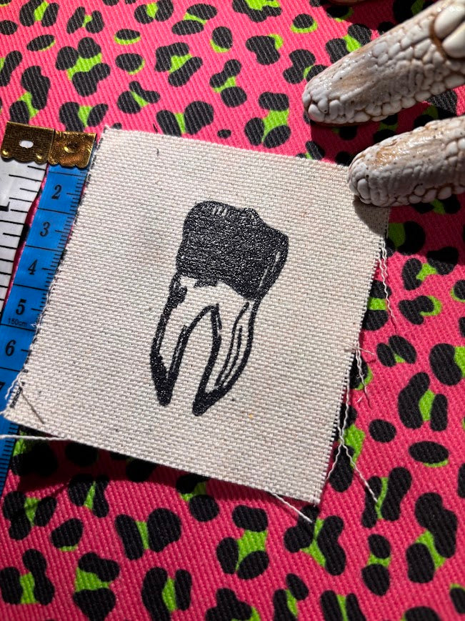 loose tooth patch. a mini patch with one toof