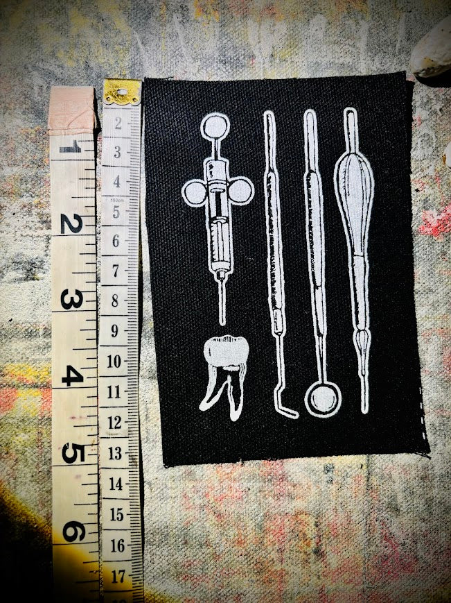 Dental tools and a toof patch.