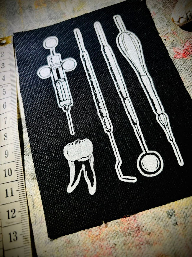 Dental tools and a toof patch.