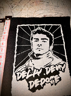 Luigi Mangione, Delay Deny Depose patch.