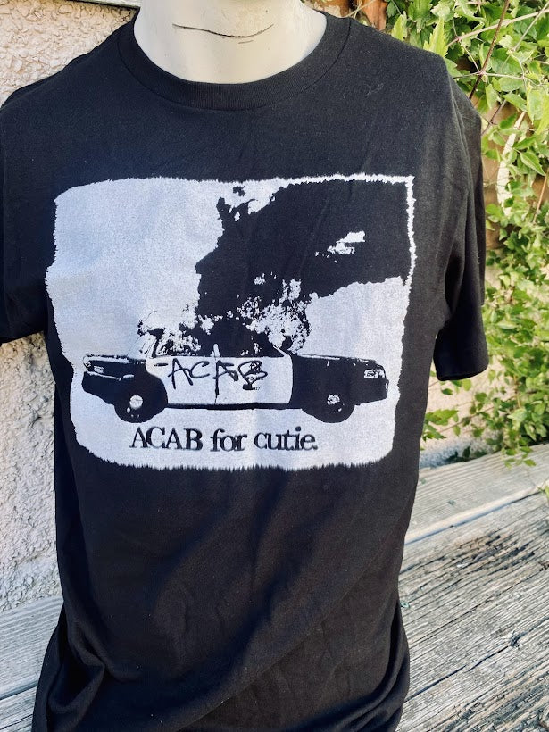 ACAB for Cutie tee. T-shirt with a burning cop car on it