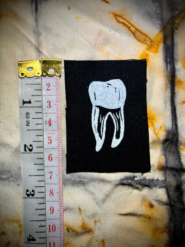 loose tooth patch. a mini patch with one toof.