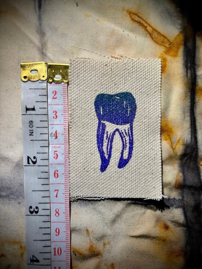 loose tooth patch. a mini patch with one toof.