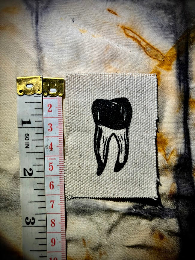 loose tooth patch. a mini patch with one toof.
