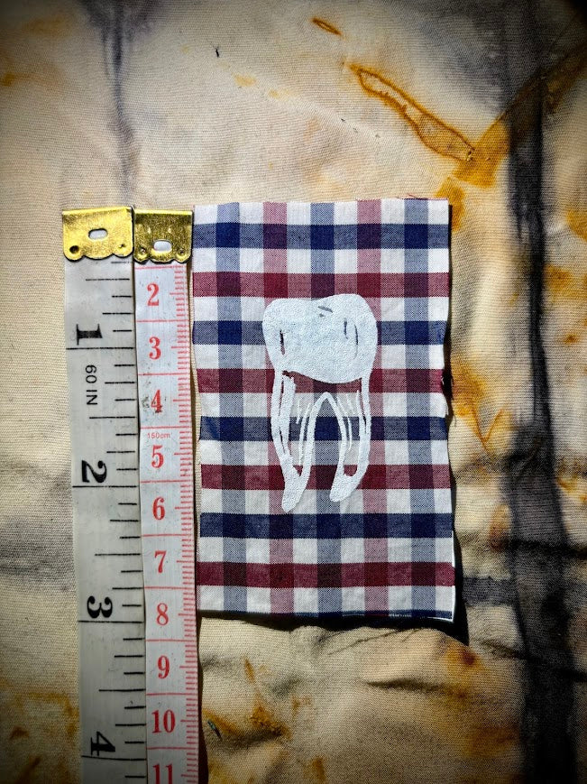 loose tooth patch. a mini patch with one toof.