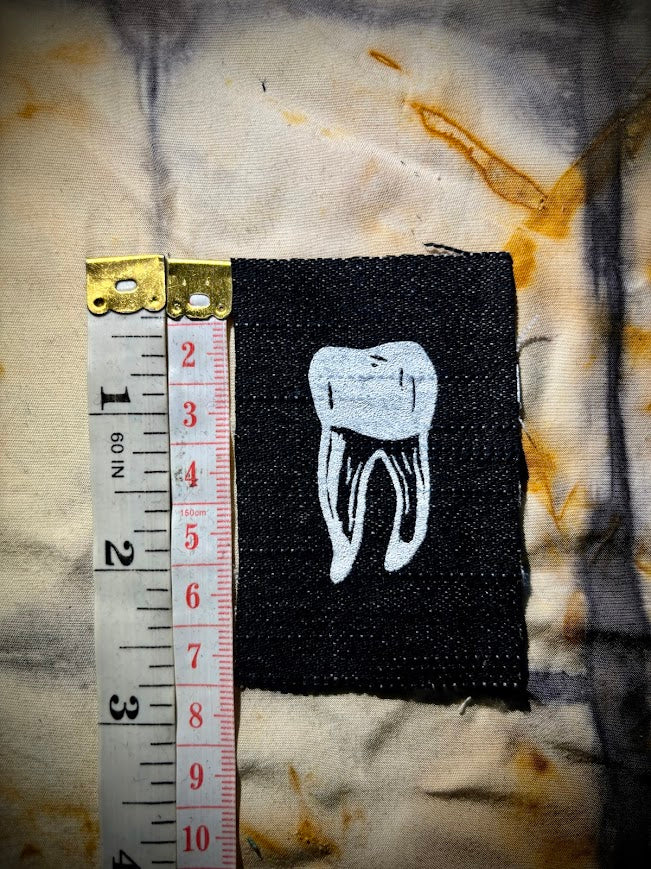loose tooth patch. a mini patch with one toof.