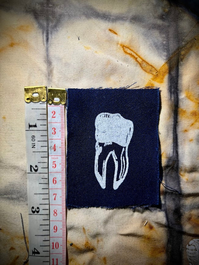 loose tooth patch. a mini patch with one toof.