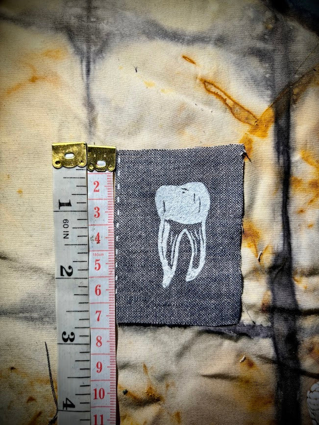 loose tooth patch. a mini patch with one toof.