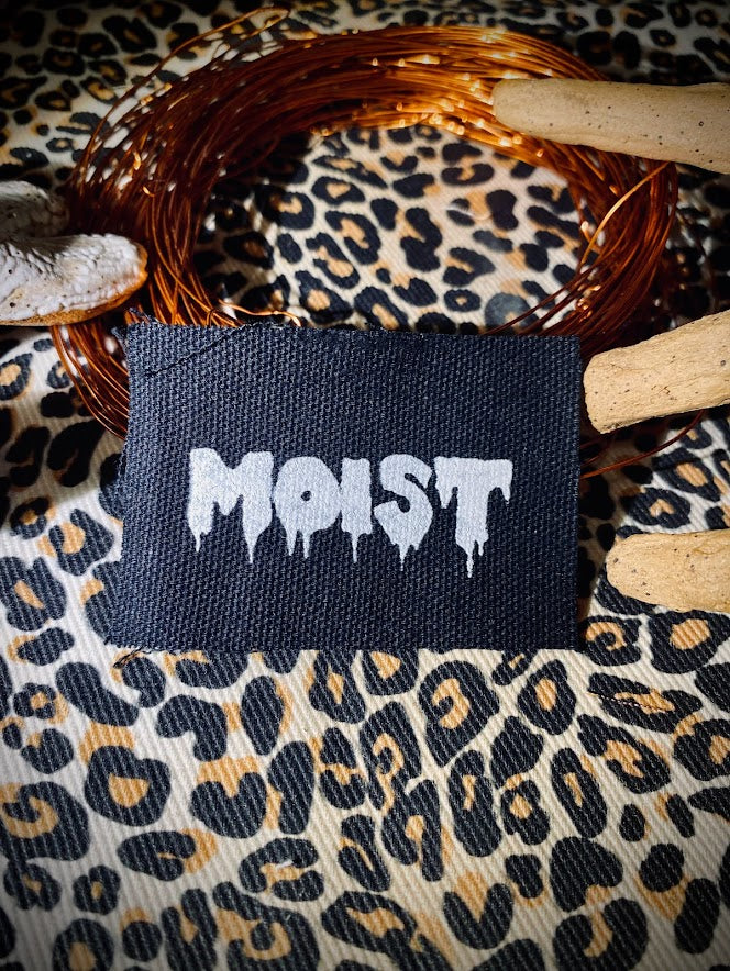 Moist mini patch. it says moist in a wet drippy font