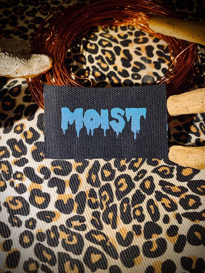 Moist mini patch. it says moist in a wet drippy font