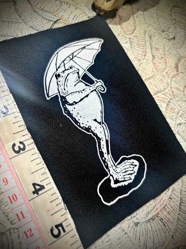 Sad frog holding an umbrella in the rain sew on patch