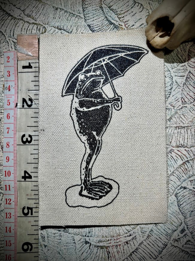 Sad frog holding an umbrella in the rain sew on patch