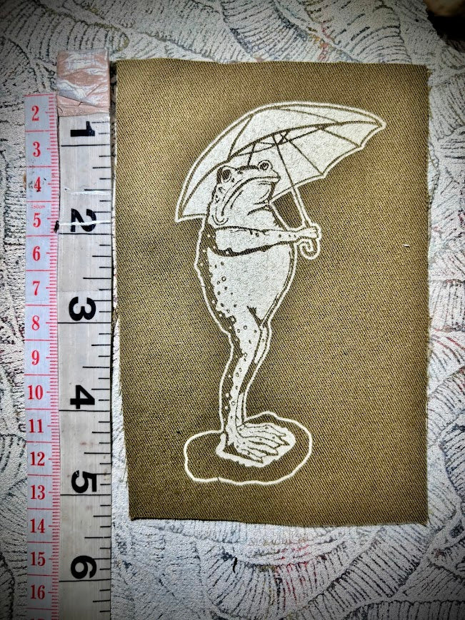 Sad frog holding an umbrella in the rain sew on patch