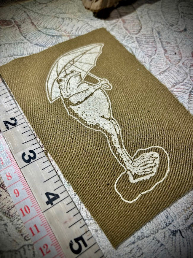 Sad frog holding an umbrella in the rain sew on patch