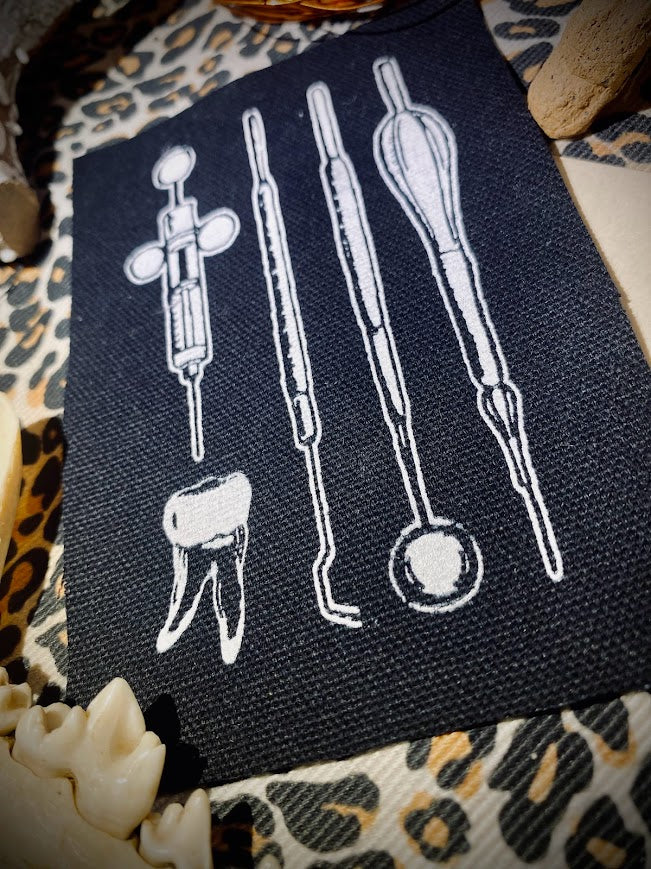 Dental tools and a toof sew on patch