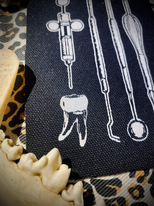 Dental tools and a toof sew on patch