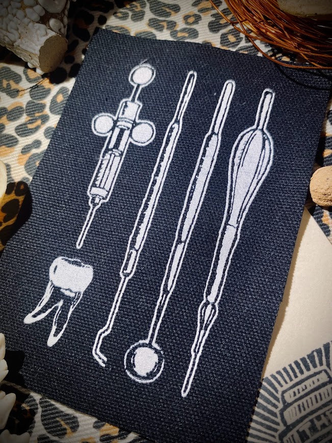 Dental tools and a toof sew on patch