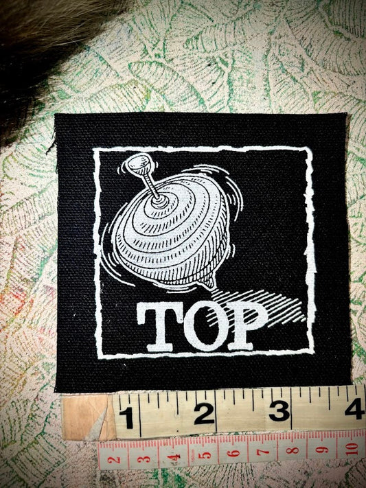 Top, completely innocent double entendre patch.