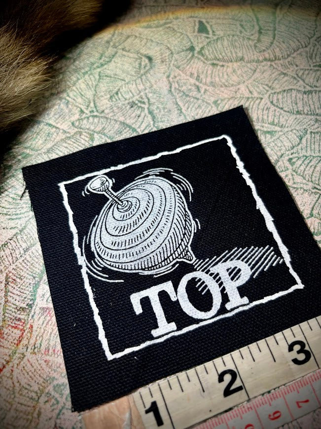 Top, completely innocent double entendre patch.