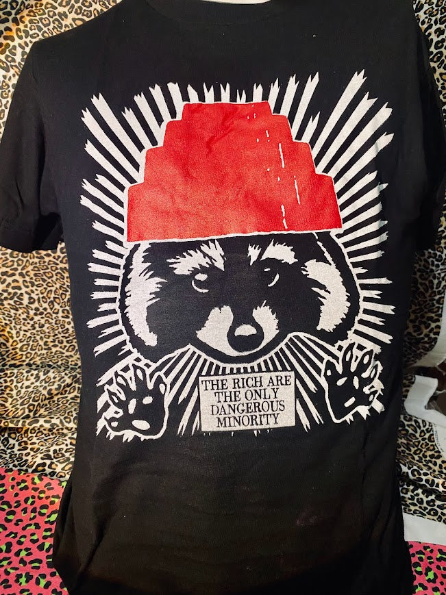 The rich are the only dangerous minority, with a raccoon wearing a devo hat