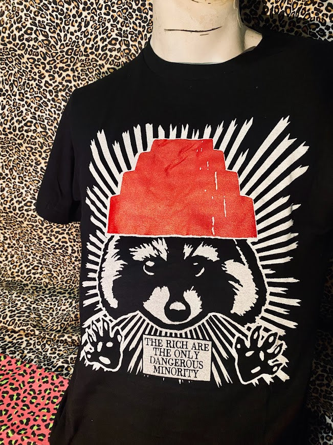 The rich are the only dangerous minority, with a raccoon wearing a devo hat