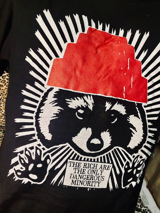 The rich are the only dangerous minority, with a raccoon wearing a devo hat