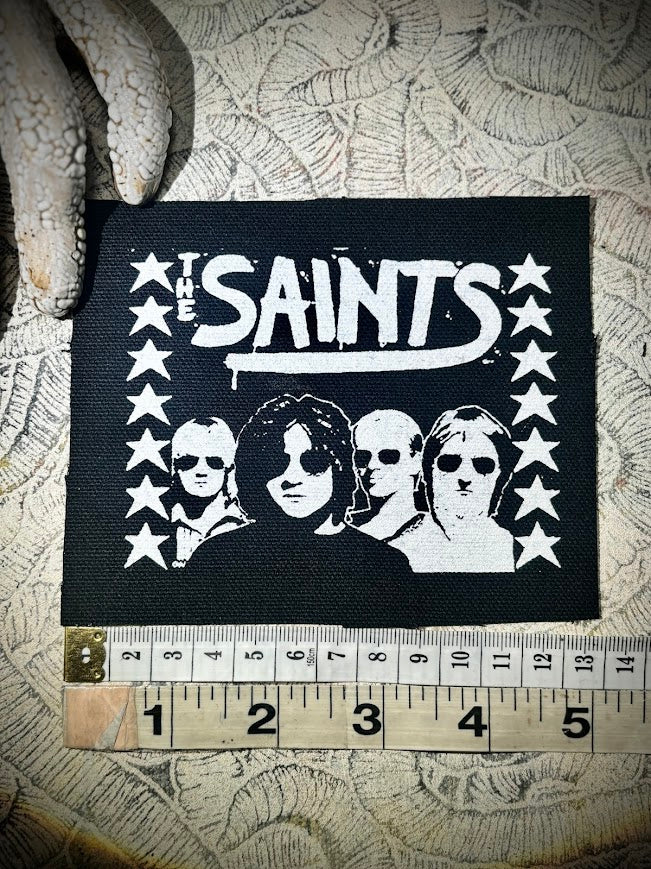 The Saints sew on patch.