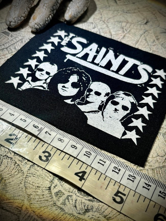 The Saints sew on patch.