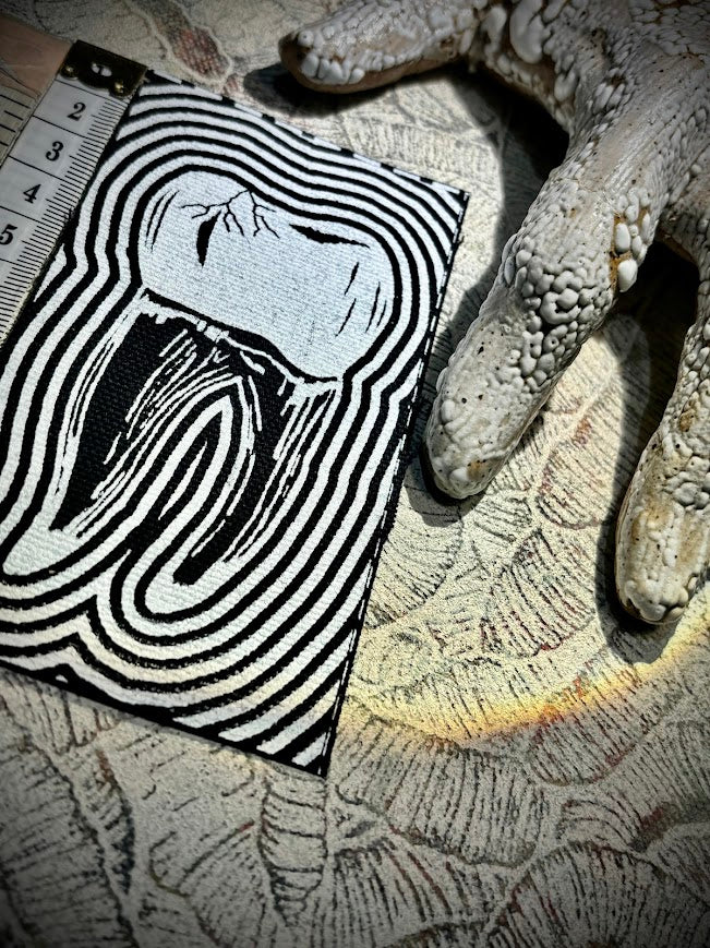 Tooth with a toothache patch.