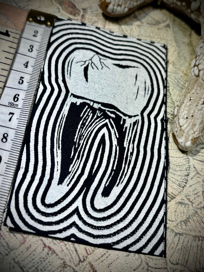 Tooth with a toothache patch.