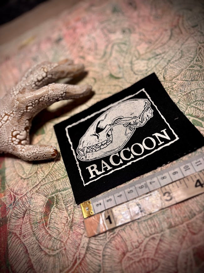Raccoon skull patch.