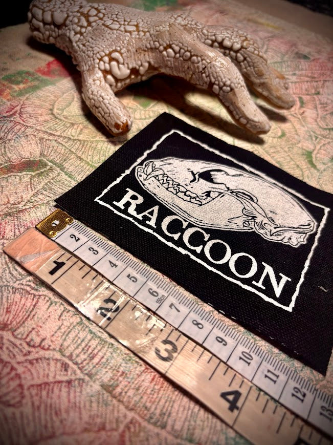 Raccoon skull patch.