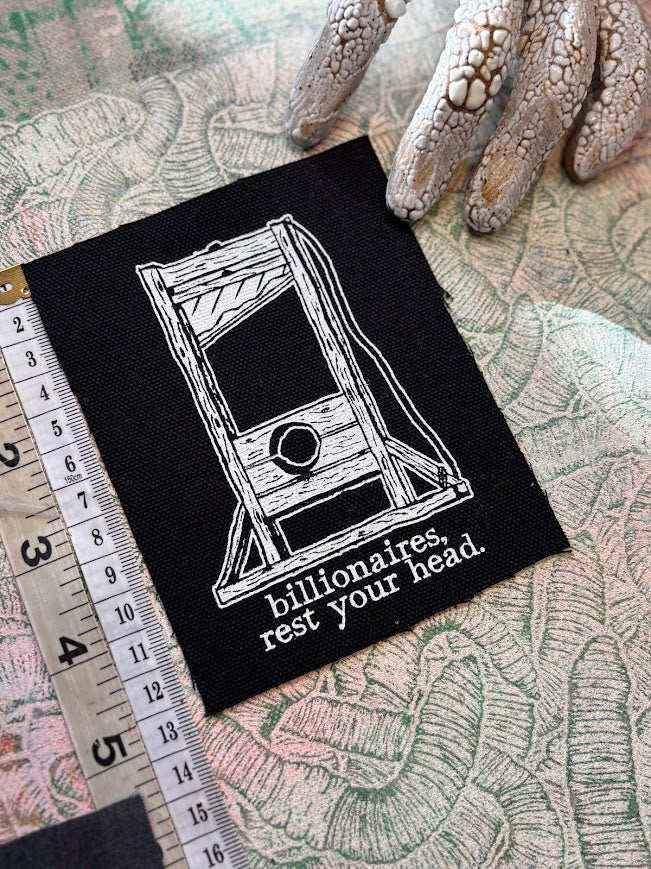 Guillotine sew on patch. Billionaires, rest your head