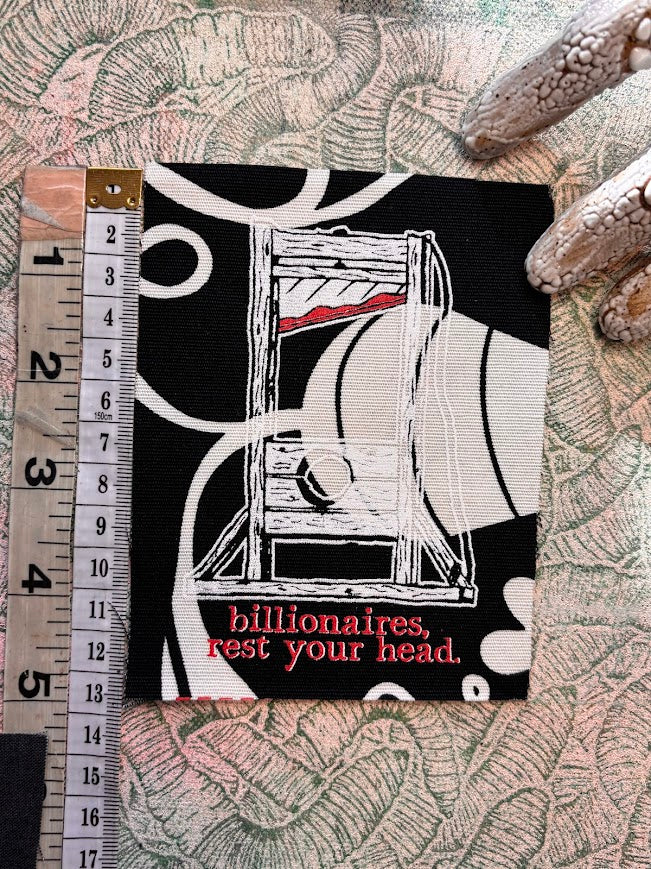 Guillotine sew on patch. Billionaires, rest your head