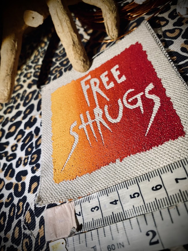 Free Shrugs sew on patch. never mind free hugs, you get free shrugs.