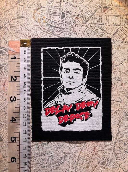 Luigi Mangione, Delay Deny Depose patch