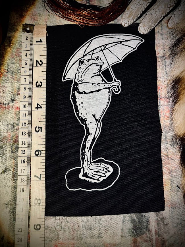 Sad frog holding an umbrella in the rain sew on patch.