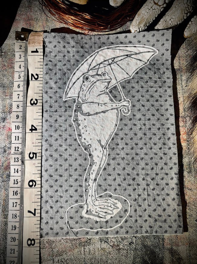 Sad frog holding an umbrella in the rain sew on patch.