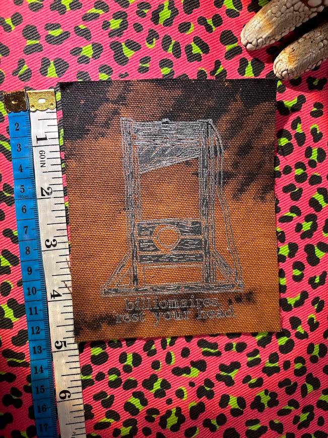 Guillotine sew on patch. Billionaires, rest your head