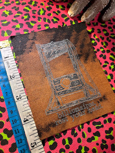 Guillotine sew on patch. Billionaires, rest your head