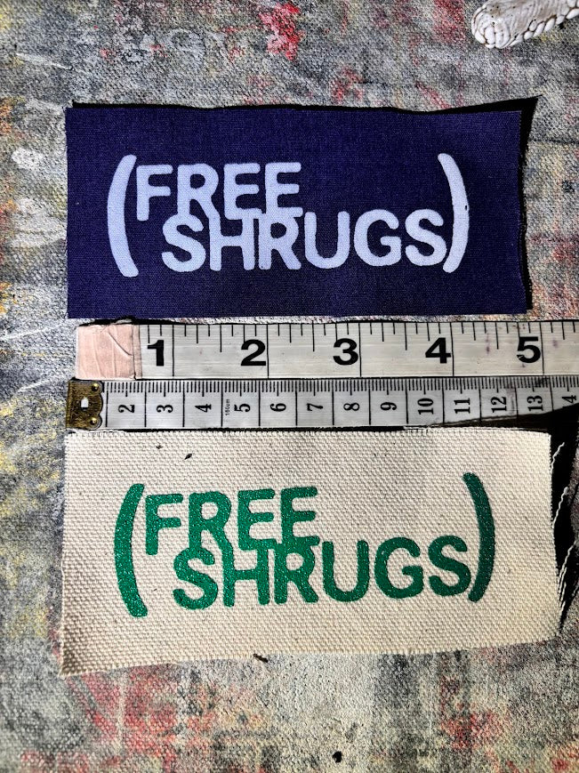 Free Shrugs sew on patch. never mind free hugs, you get free shrugs.